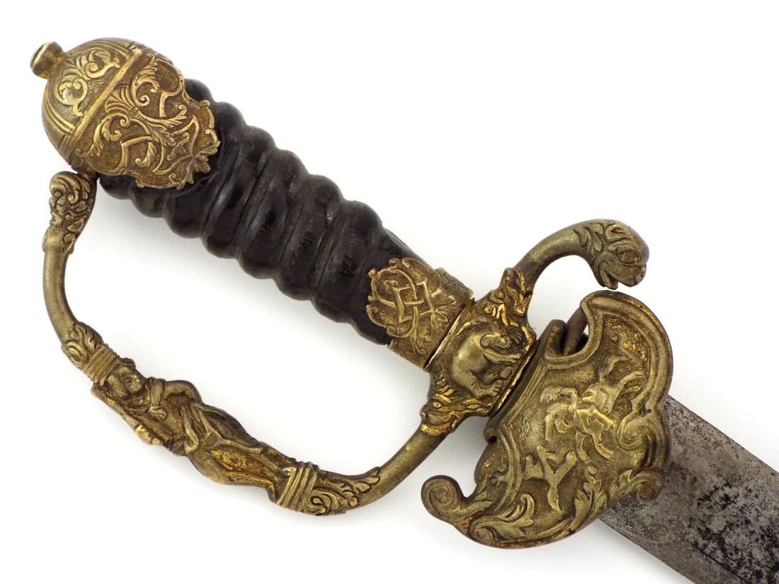Very Good 17th C. Continental HUNTING SWORD Horn Hilt: Very good nobleman 17th century continental hunting sword with a straight double edged blade etched in partial "1673" script, veiled in greyish patina. The ornate gilded brass hilt alive with relief