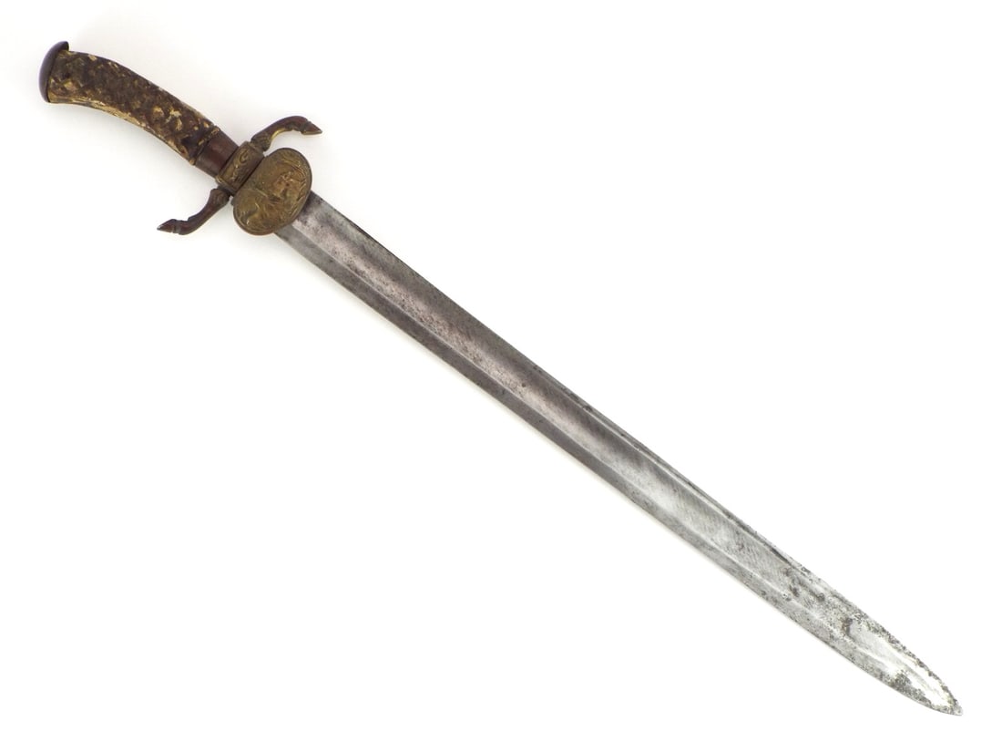 American 1800s Hunting Sword GERMAN IMPORT By N.Y. Retailer: Single edged steel blade features central fuller with surface spotting, age toning and ricasso stamped by faint retailer mark and NY. Cast brass crossguard displays stag hoof quillons and detailed rai