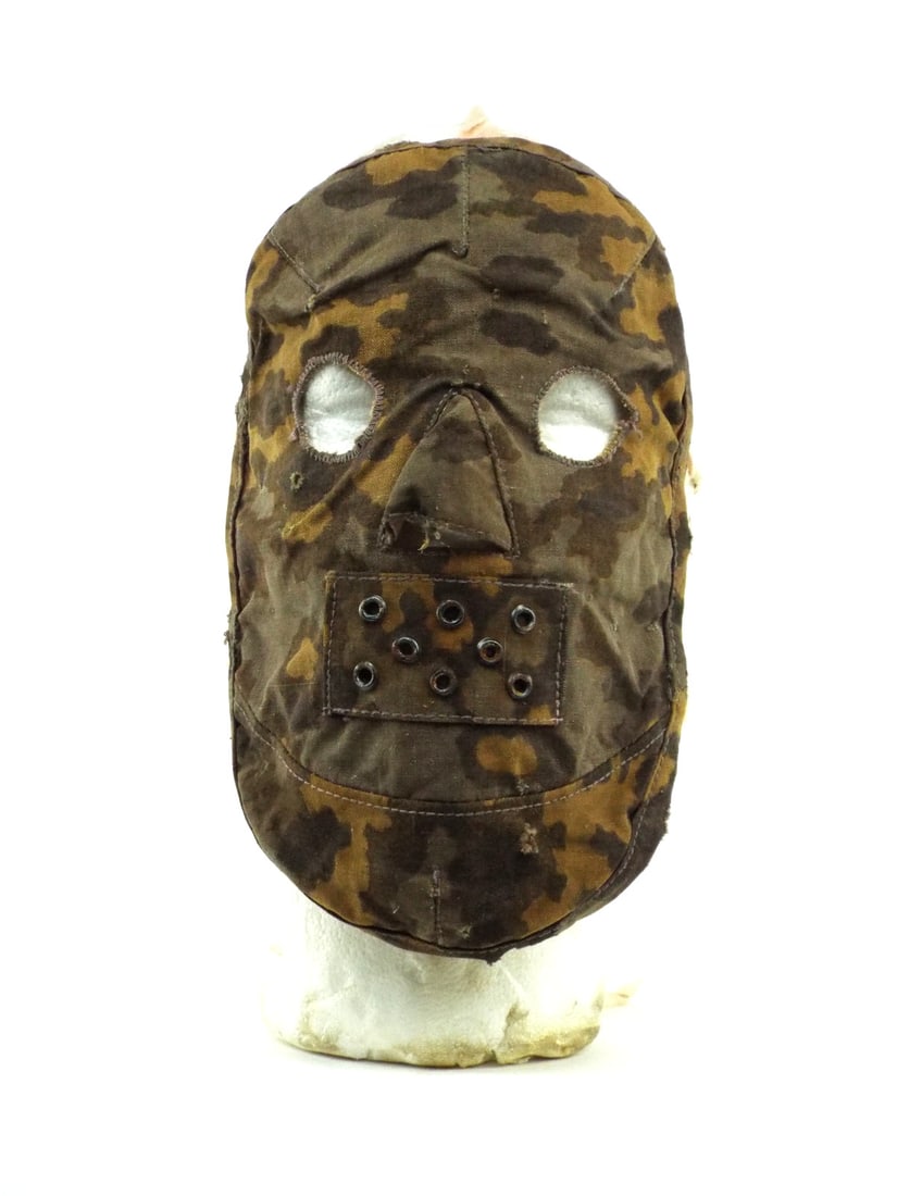 Very Rare German WWII WAFFEN-SS SNIPER MASK Plane Tree Camouflage: Textile body shows autumn tree print on heavy cotton duck with honest oxidation to the eight steel ventilation grommets. Eye apertures feature period zigzag reinforcement stitching with minor fraying.