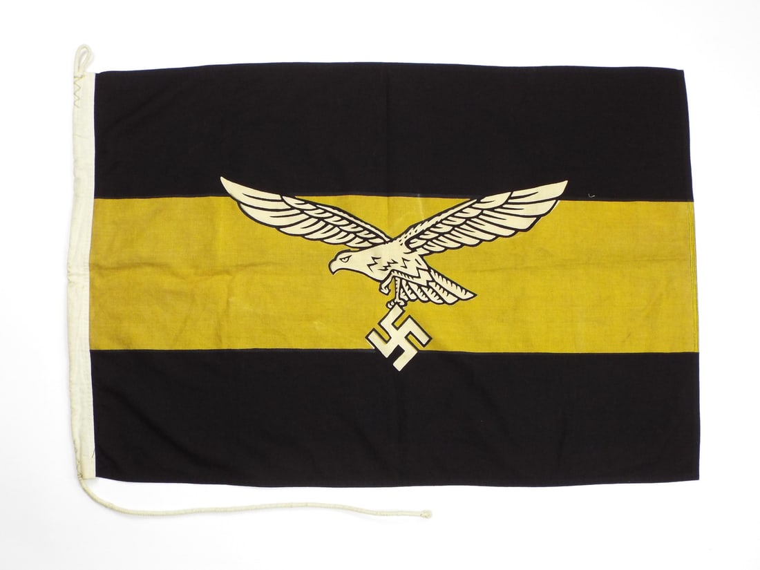 German WWII Luftwaffe Geschwader Kommodore COMMAND FLAG: Black and gold bunting body displays central Luftwaffe flying eagle motif holding traditional emblem, exhibiting light age toning and minor surface soils. Double stitched perimeter seams retain solid 