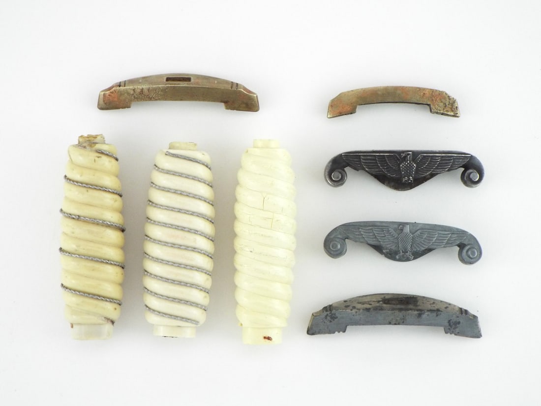 Group of German WWII Heer Officer Dagger Hilt Components: Group of spare officer dagger hilt components comprising spiral fluted celluloid grips, two displaying wire wrap, paired with cast alloy eagle crossguards showing light surface wear and minor tarnish 