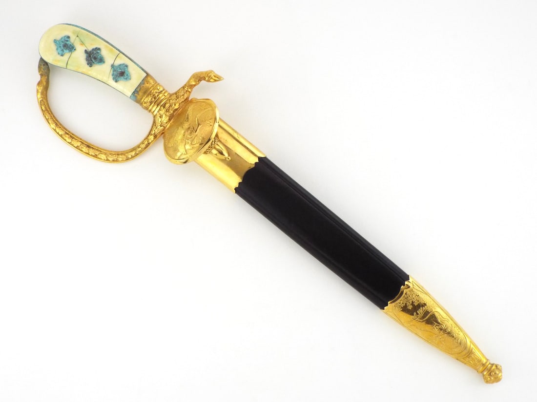 German Post WWII Hunting Dagger By EICKHORN SOLINGEN: Single edged chrome plated steel blade displays etched forest hunting motifs and clear Eickhorn maker mark near ricasso. Gilt brass hilt features shell rain guard, deer hoof quillon, knuckle bow and o