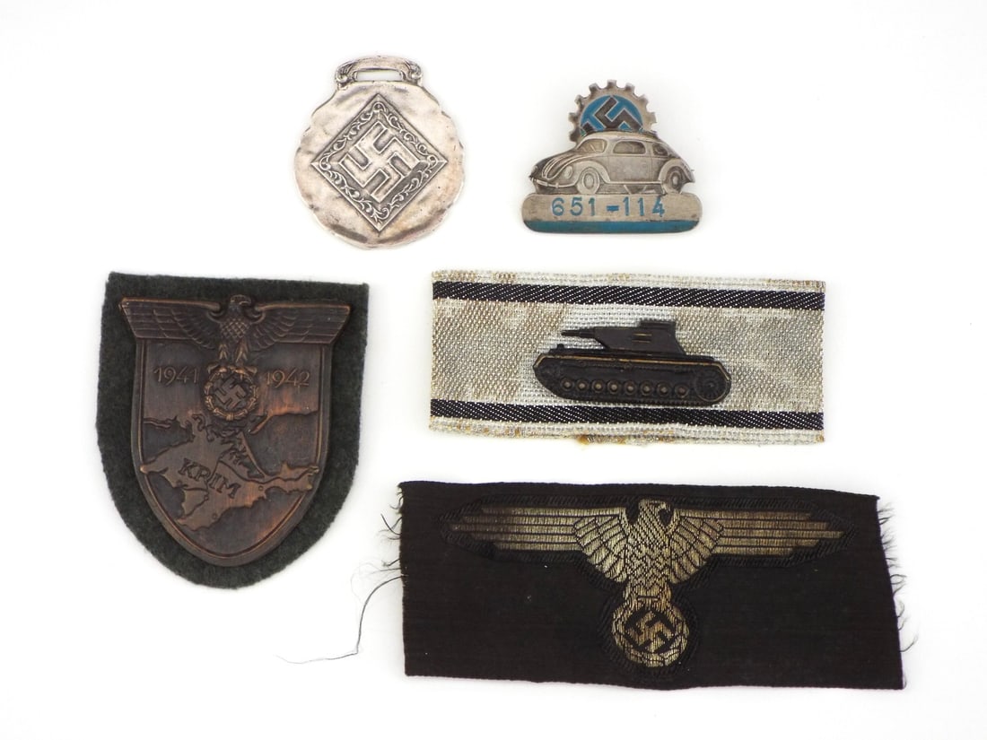 German POST WWII Badges Grouping: Comprehensive insignia group featuring a die struck Crimea shield displaying light surface tone on field grey wool backing, a gold embroidered sleeve eagle showing minor fraying, a tank destruction st