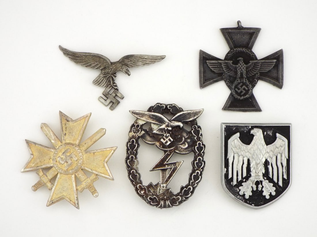Lot of German POST WWII Badges: Collection of military and service awards displaying varying aged patina, light surface wear and intact reverse attachments, featuring a Luftwaffe eagle insignia, Police service cross, War Merit Cross