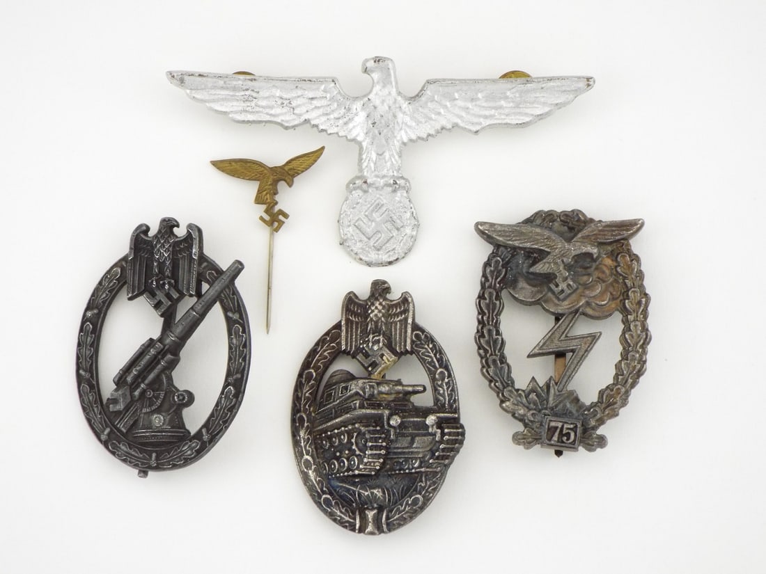 German POST WWII Luftwaffe & Heer Badges & Eagles Lot: Includes a zinc Air Defense Badge, Armored Assault Badge, Ground Assault Badge with 75 engagement plaque, silvered cap eagle and flying eagle pin, exhibiting varied surface patina, localized tarnish, 