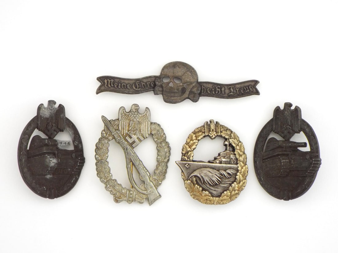 Lot of German POST WWII Military Badges and Pins: German WWII lot of military badges and pins including two Panzer Assault Badges with surface wear, an Infantry Assault Badge stamped AUSTRIA to the reverse showing pin assembly, a Destroyer War Badge 