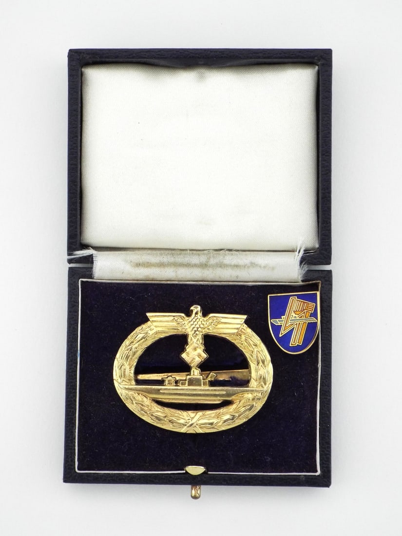 German Cased Post WWII U-BOAT WAR BADGE with Enamel Lapel Pin: Expertly struck gilt metal badge features crisp details depicting a submarine within a laurel wreath topped by the Reich eagle, displaying a bright gold finish with minimal high point friction wear, r