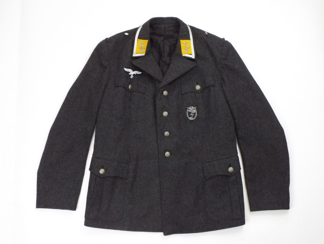 German Post WWII In Style of WWII Luftwaffe Tunic By CARL WEYERS & Silver Tress: Post war wool body exhibits light wear with tight stitching, clean lining and WWII Luftwaffe insignia including a embroidered breast eagle and a metal radio operator badge. High grade collar featuring