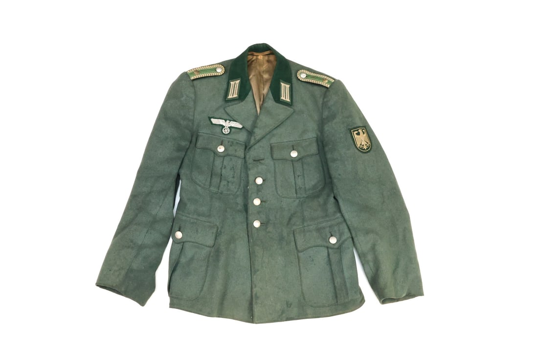 West German Cold War Border Guard NCO Service Tunic NORTH BORDER: Service tunic in field wool featuring a dark green velvet collar with double bar collar tabs, sewn sleeve eagle badge and shoulder boards displaying rank braid with a single pips button. Wool shell ex