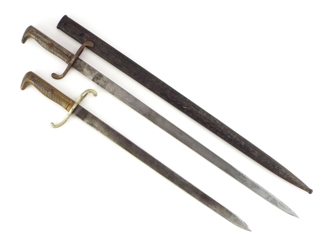 German Imperial WWI Bayonet Pair ETCHED BLADE & BRASS HILT: Pair includes an infantry sidearm with a single edged, fullered blade displaying light patination and fine etched floral motifs, fitted to a brass cast grip featuring an L-shaped spring and S-curved c