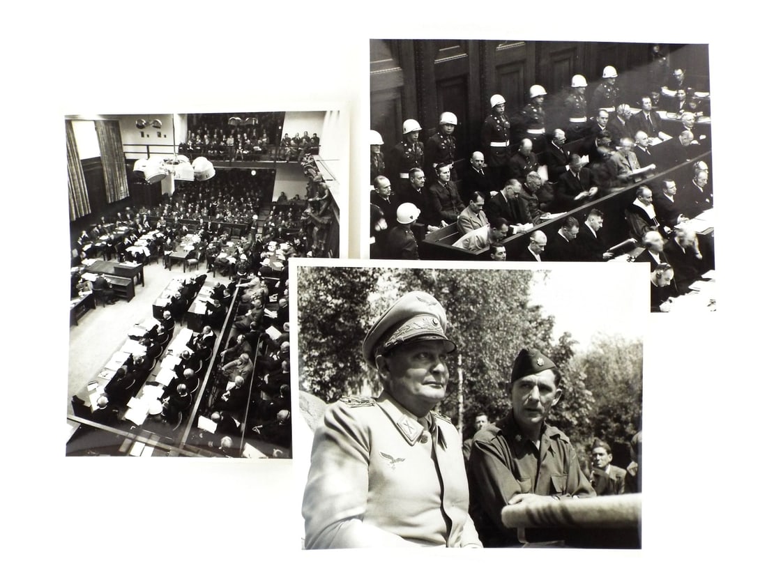 US WWII NUREMBERG TRIALS PRESS PHOTOGRAPHS By Signal Corps: Silver gelatin prints on heavy stock displaying expected edge toning and minor surface handling consistent with age. Depicts Hermann Goering in captivity, May 1945. Courtroom views dated November 20, 