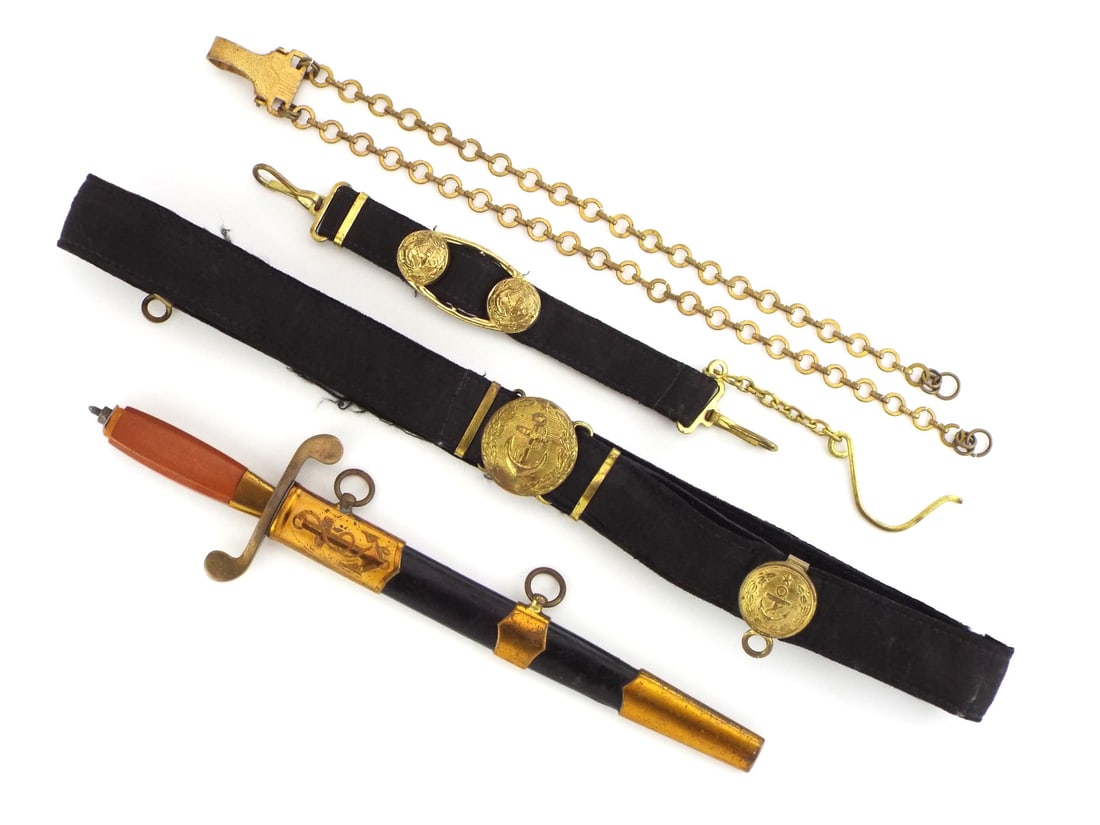 Soviet Post WWII Naval Officer Dagger with GILDED HANGER STRAPS: Straight double edged steel blade displaying mirror polish with BULAT 1983 maker stamp to obverse ricasso and serial number 139817 to reverse. Brass S-shaped crossguard with orange Bakelite grip showi