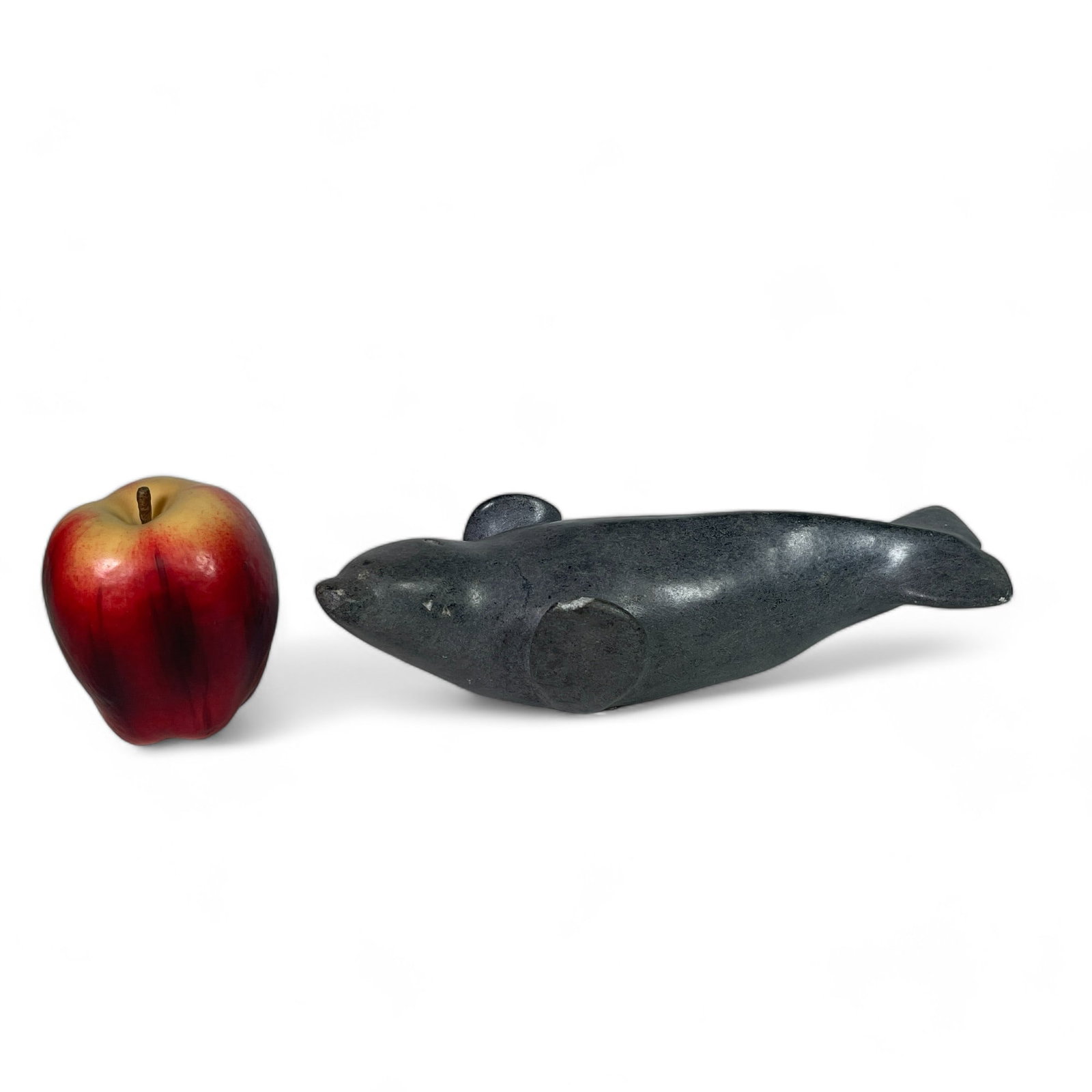 Inuit Carving of a Seal: Measures 10" wide, 3 3/4" deep, 2 1/2" tall. Has a chip.