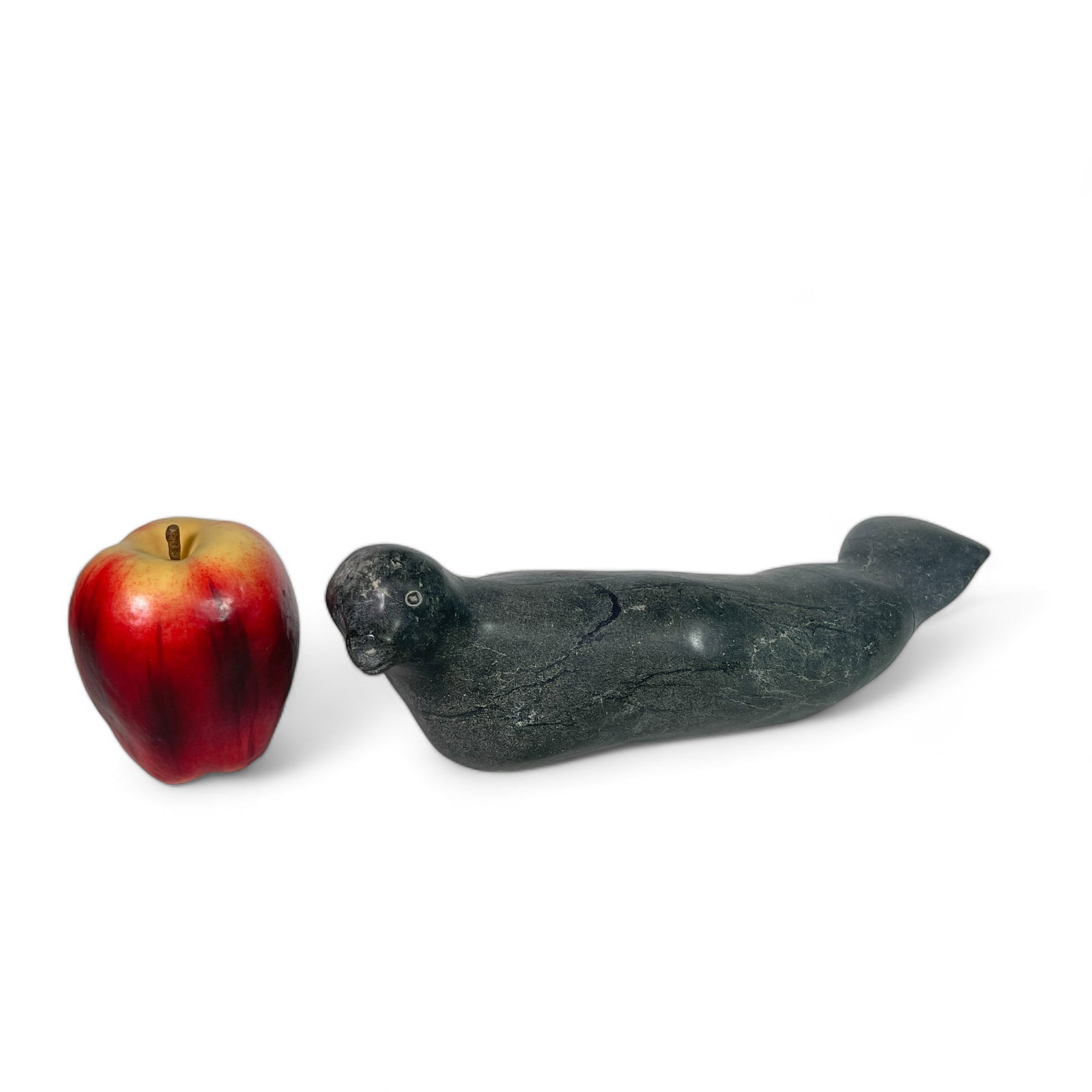 Inuit Carving of a Manatee: Measures 11 1/2" wide, 5 1/2" deep, 3 1/2" tall. Repaired tail.