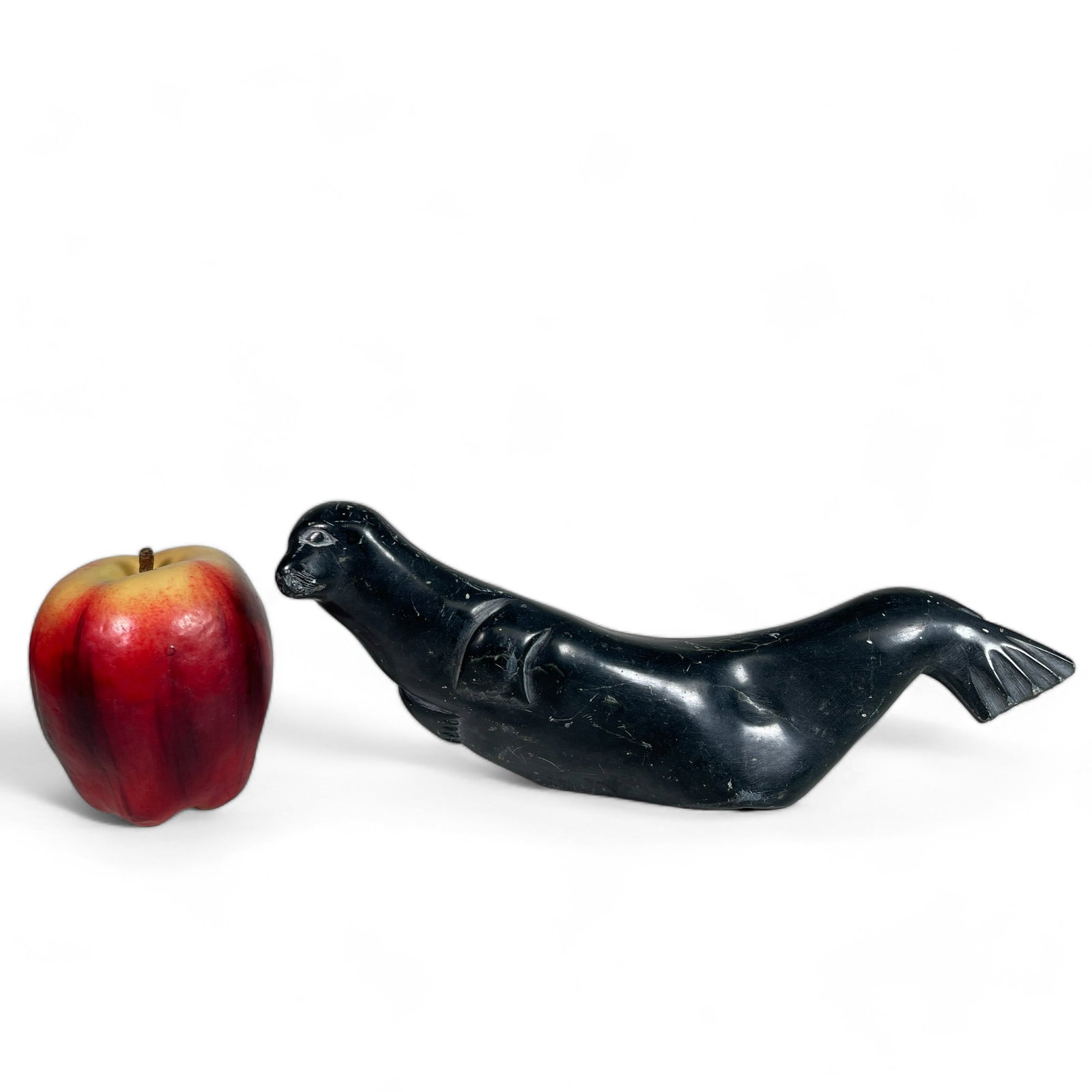 Inuit Carving of a Seal: Measures 10" wide, 2 1/8" deep, 4 1/4" tall.