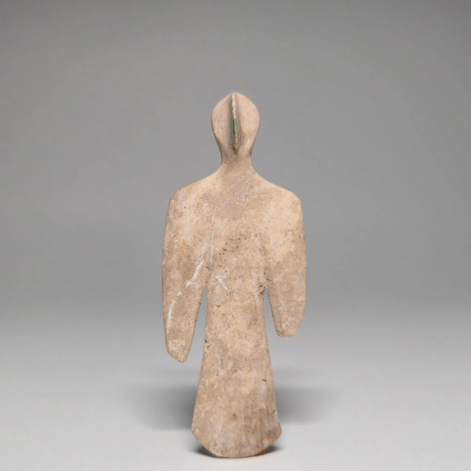 A bactrian marble idol of a winged man: BACTRIAN WHITE STONE IDOL OF A BIRD MAN.Circa 3rd Millennium B.C.The stylized figure with a slender body and tapering arms, the beaked nose projecting from the top of the spade-shaped face 9.7 cm. hig