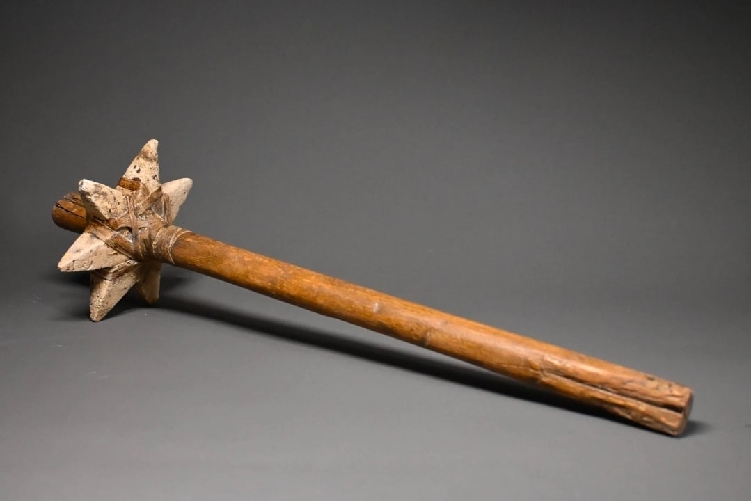 An egyptian wooden mace or weapon: An Ancient Egyptian wooden ceremonial mace or ritual weapon,Naqada III to Early Old Kingdom, circa 3200–2600 BCE. composed of a long tapered wooden shaft fitted with a rare star-shaped mace head, li