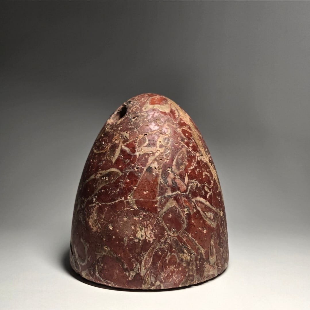 A bactrian stone weight: A BACTRIAN STONE WEIGHT, CIRCA LATE 3RD TO EARLY 2ND MILLENNIUM BCOxus Civilization. Of high domed form supported on a slightly rounded base, perforated for suspension at the top, the holes converging