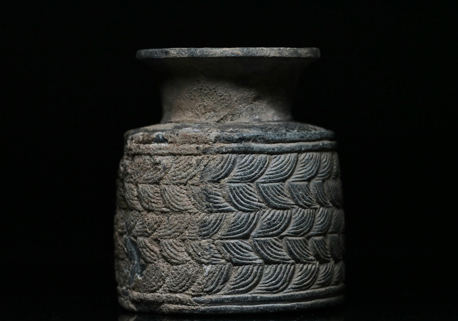 A bactrian chlorite stone jar: Ancient Central Asia, Bactrian/jiroft ca. 2500 to 2250 BCE. A beautiful jar of a squat form with a flat base, a cylindrical body, and a tubular neck with a flared rim, hand-carved from grey-blue chlor