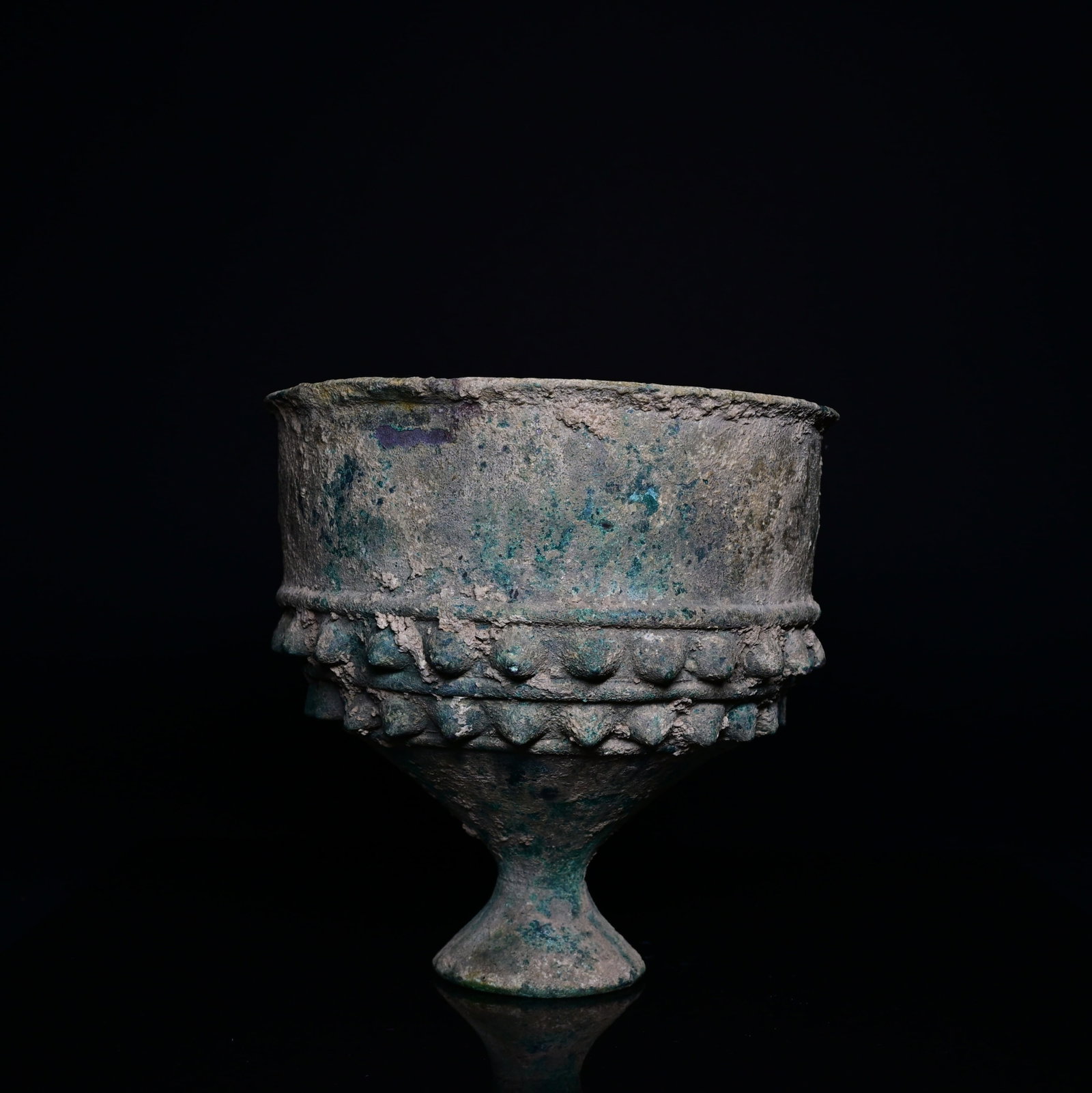 An urartian bronze goblet: 6-8thCentury urartian finely cast bronze goblet raised on a slender pedestal foot, characteristic of the metalworking traditions of the ancient Kingdom of Urartu. The vessel features a broad cylindric