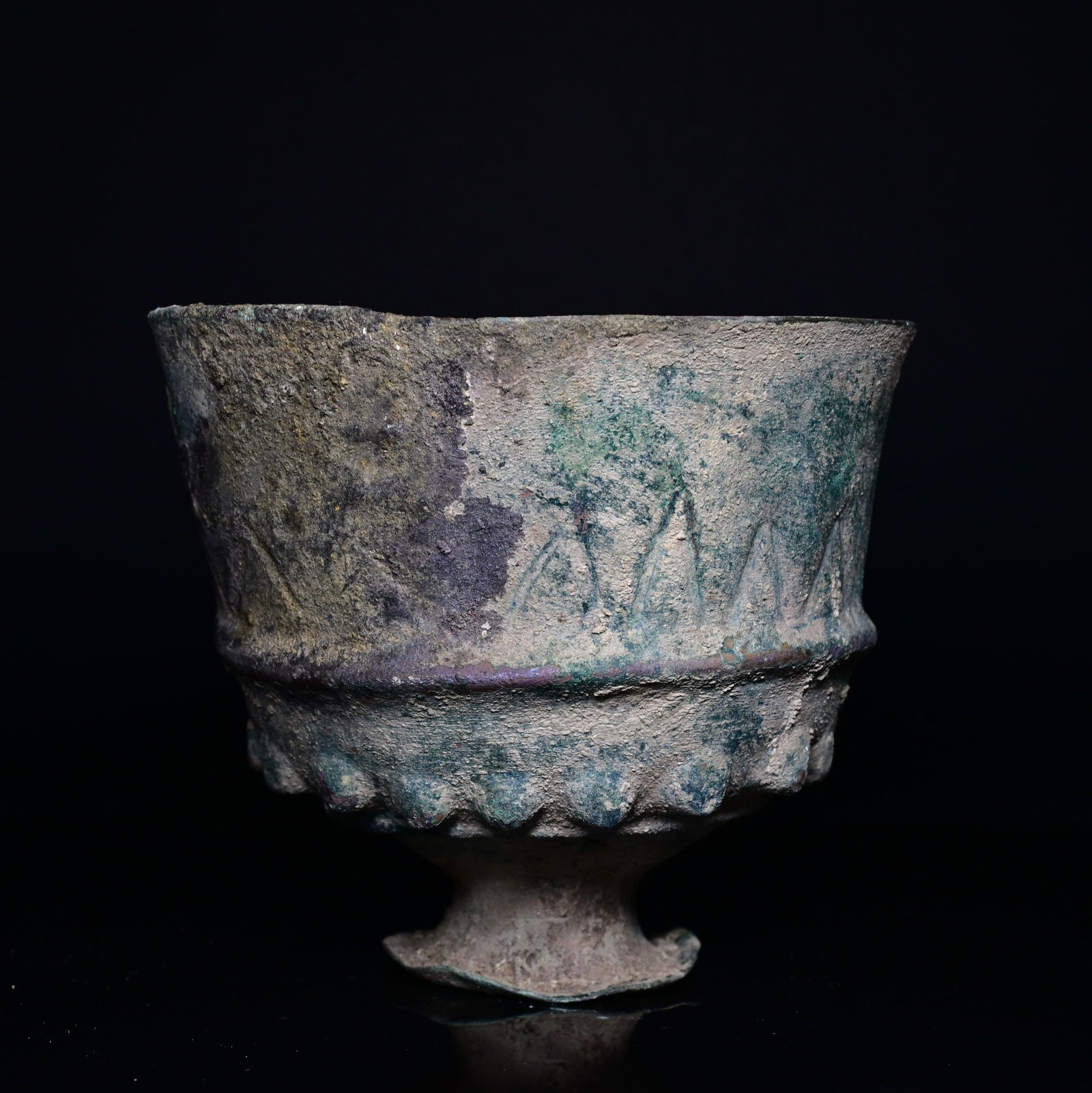 An urartian bronze goblet: 6-8thCentury urartian finely cast bronze bronze goblet of elegant tapering form, standing on a small flared pedestal foot. The vessel is decorated with a band of embossed triangular bosses encircling 