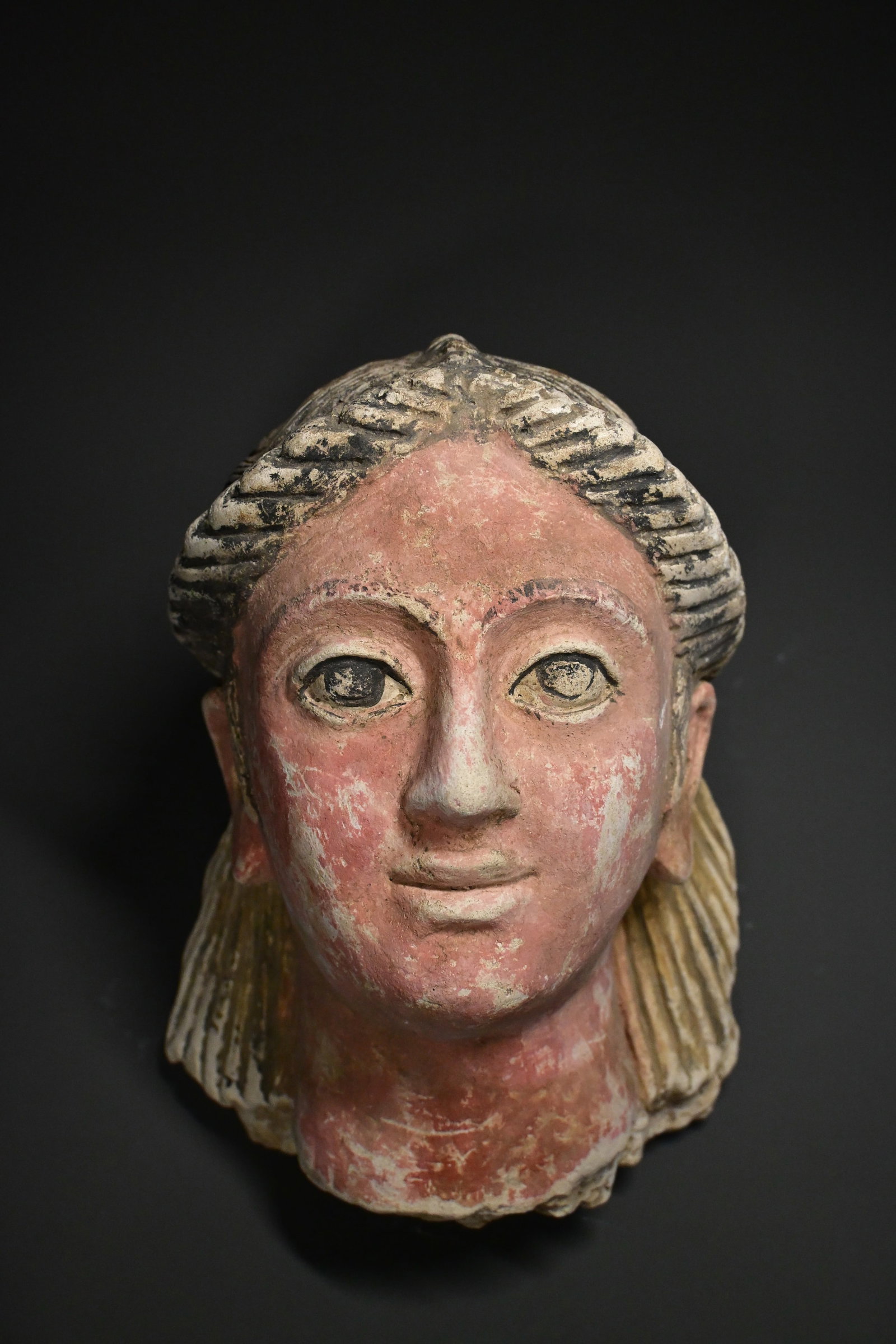 Romano- egyptian stucco mask of a woman: Romano-Egyptian Painted Funerary Mask of a Woman, 2nd Century A.D.A finely modeled Romano-Egyptian painted funerary mask depicting a woman with large expressive eyes, delicately arched brows, and a se