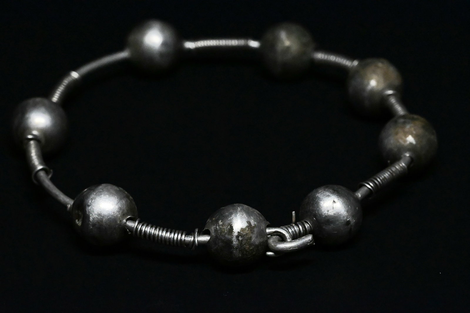 Hellenistic Greek silver bracelet: Ancient Greek Silver Bead BraceletGreek, Hellenistic Period, ca. 3rd–1st Century BCA finely crafted Ancient Greek silver bracelet composed of a series of hollow spherical silver beads strung along