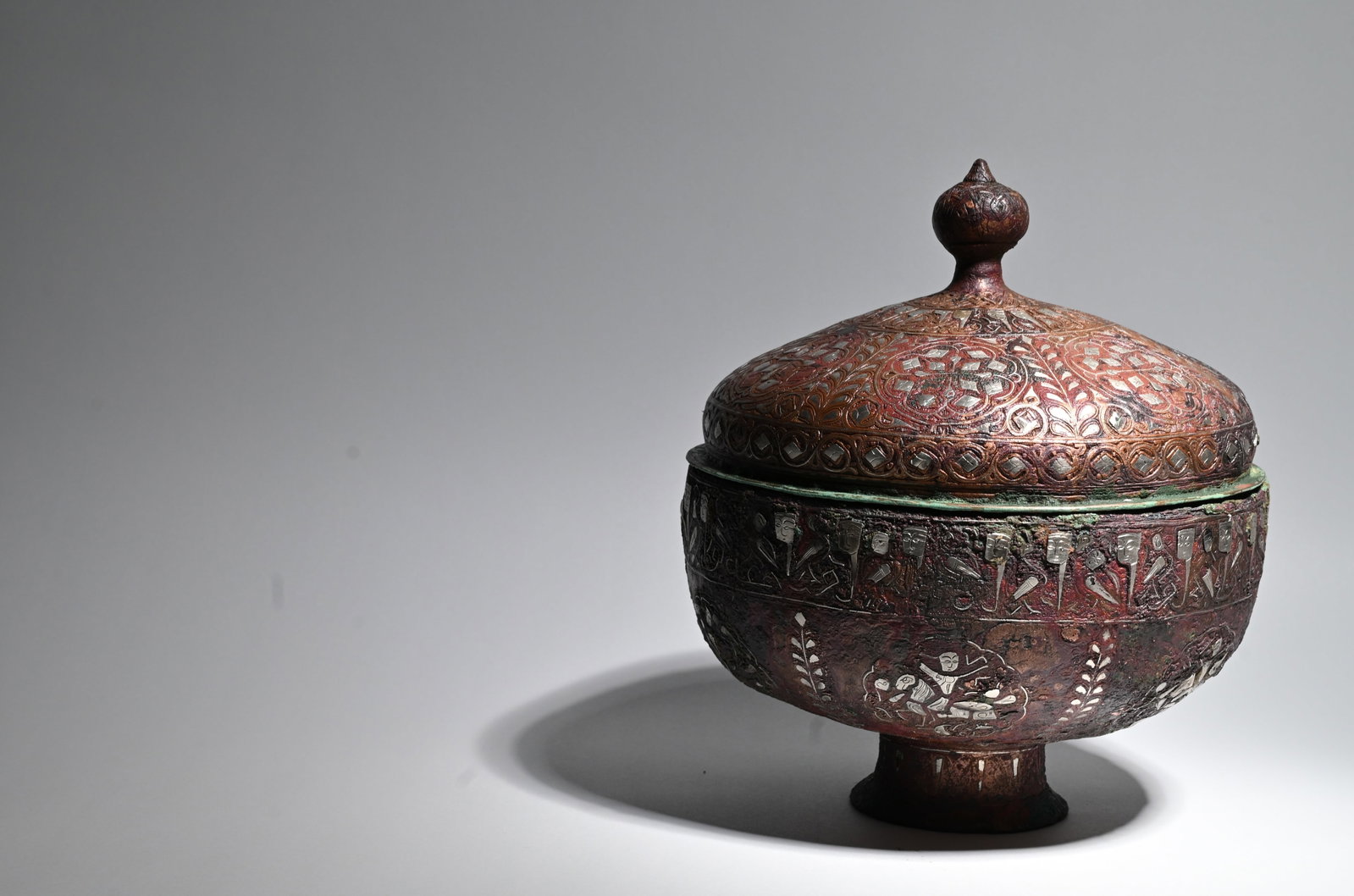 A Khurasan silver-inlaid bronze lidded bowl, Persia, 12/13th century: A Fine Khurasan Silver-Inlaid Bronze Lidded BowlPersia (Northeastern Iran), 12th-13th CenturyAn exceptional Khurasan bronze lidded bowl, decorated with silver inlay, dating to the late Seljuk period (