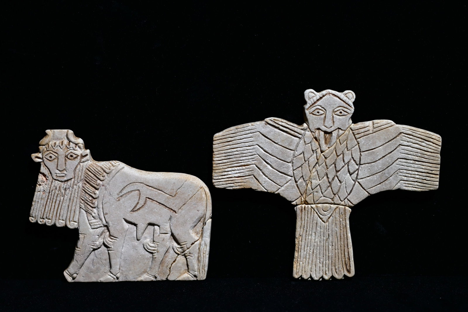 A mesapotamian limestone inlay of a bull and eagle: A pair of Mesopotamian limestone inlays depicting a human face bull and an eagleMesopotamia, 2nd millennium BC.Size: bull: 9.5cm long x 7.5cm H. Eagle: 10cm long x 9.5cm H.Provenance: property of an