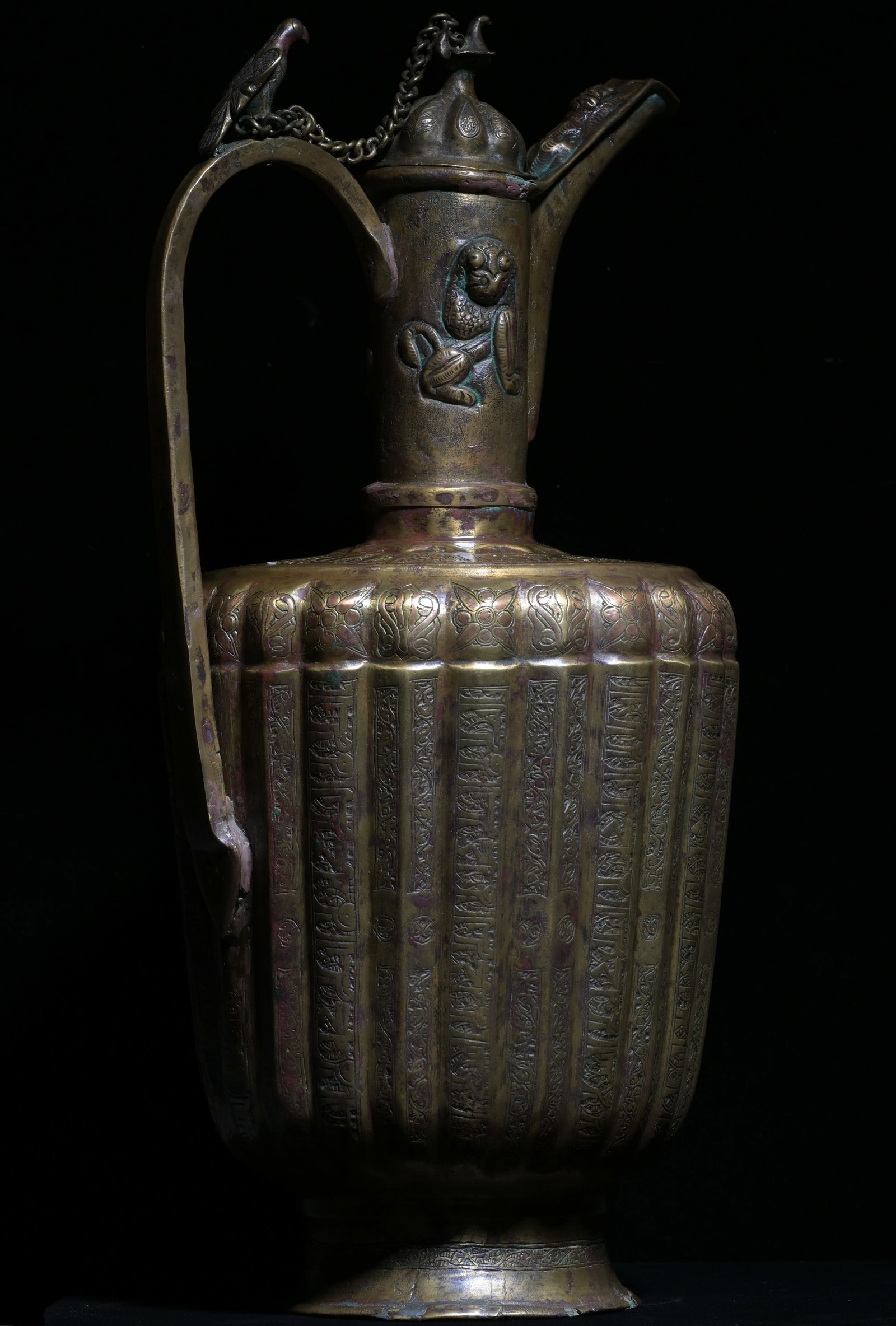 A KHORASAN SILVER AND COPPER INLAID BRONZE EWER, PERSIA, 12TH CENTURY: A KHORASAN SILVER AND COPPER INLAID BRONZE EWER WITH LID, PERSIA, 12TH CENTURY.Size: 39cm HProvenance: property of an private european collector, acquired in early 1990s