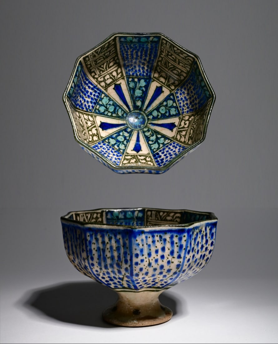 Bowl of fritware, (probably Kashan/ilkhanid, Sultanabad ware) 13-14th Century: Bowl of fritware, with underglaze painting in blue and black, Iran (probably Kashan, ilkhanid Sultanabad ware), 13th-14th century.Bowl of fritware, of decagonal shape, on high foot, painted in black a
