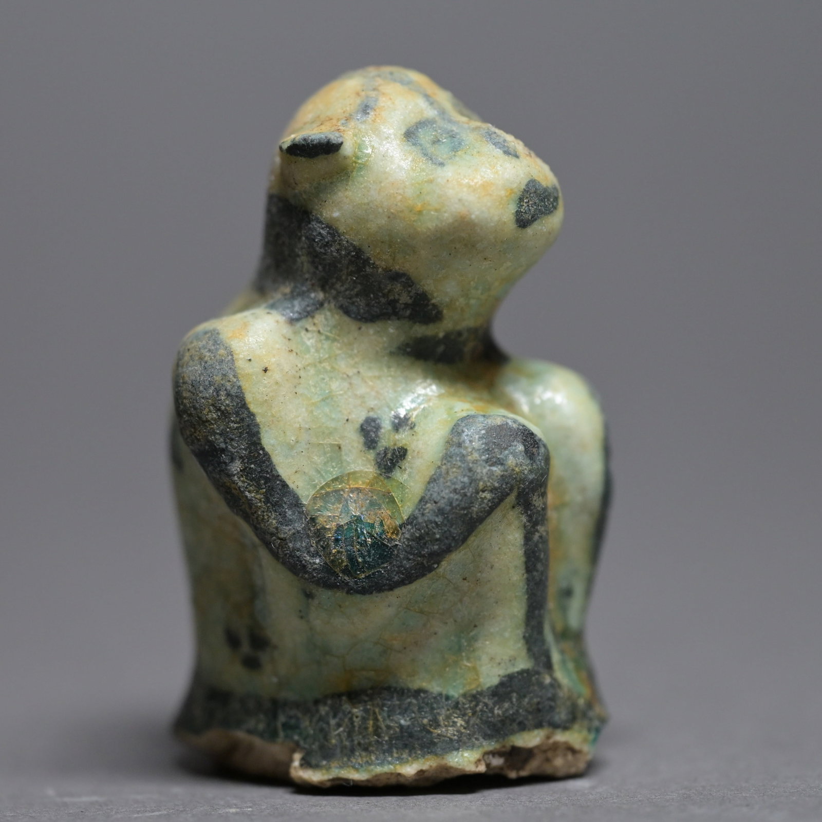 A Kashan ceramic painted figure of a seated monkey (1 of 6)