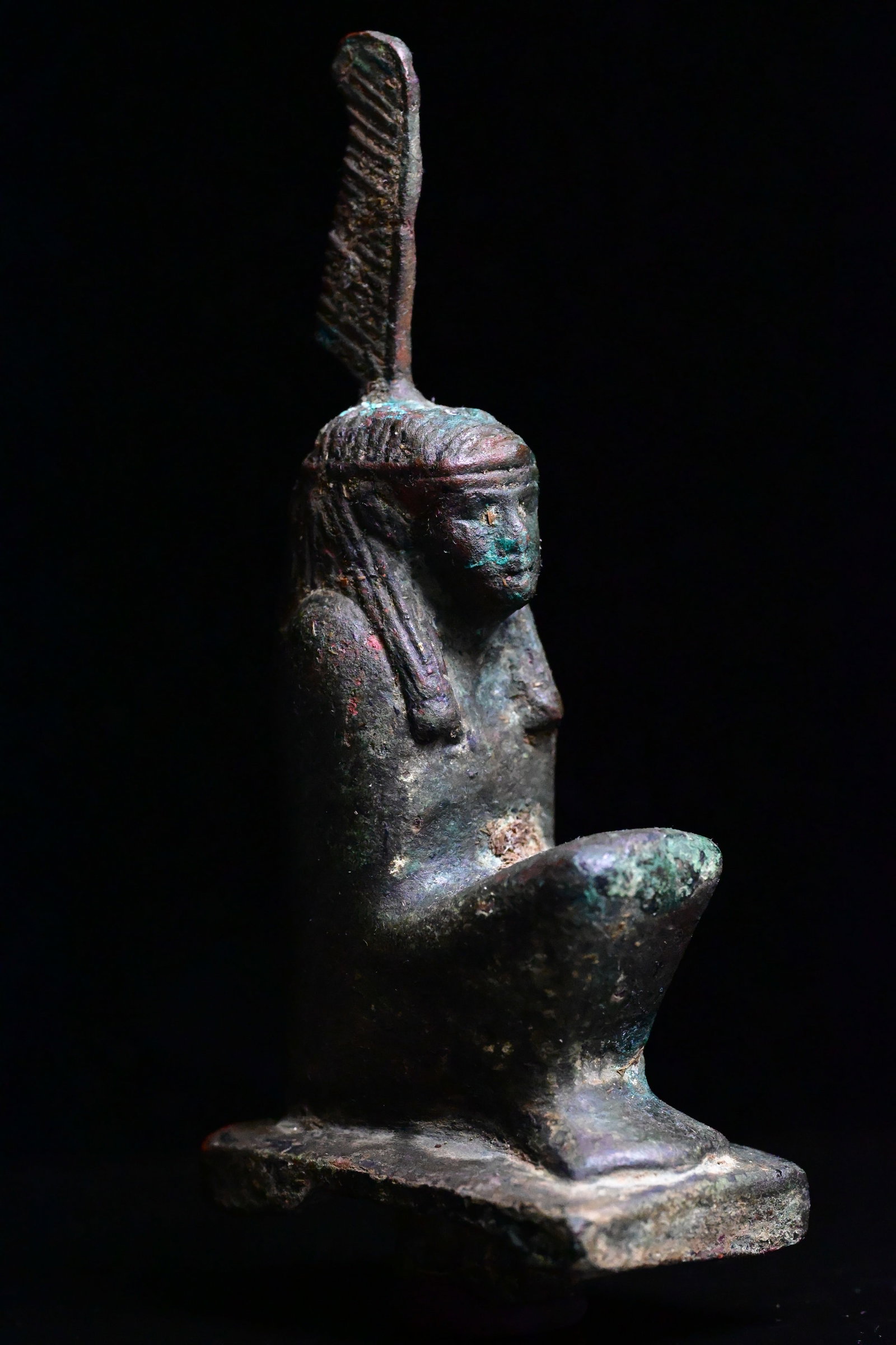 An egyptian copper squatting figure of Maat. (1 of 7)
