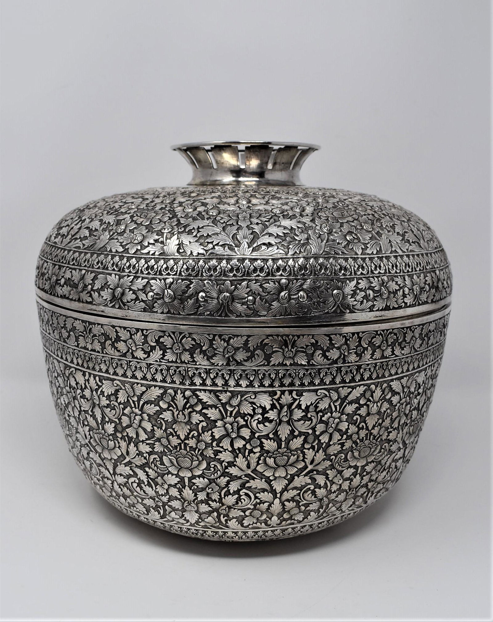Large Indian Kutch / Burmese or Cambodian? solid silver bowl and cover: A very large antique? Indian Kutch/ Burmese or Cambodian solid silver repousse footed bowl and cover, intricately decorated with a dense scrolling foliated ground between a register of split-palmettes