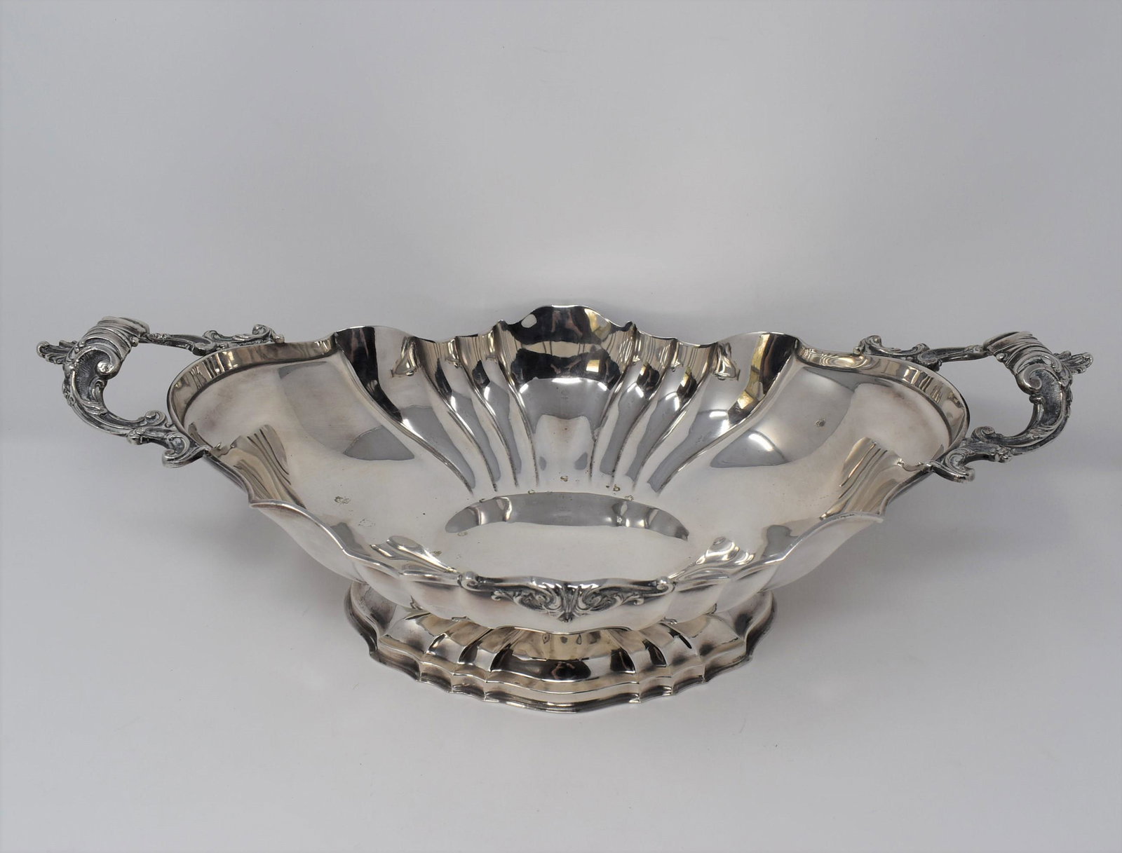 A large antique continental silver centerpiece: A large antique continental silver centerpiece with openwork handles.. Un-known origin. Marked "800". Probably made circa 1900. Approximate measurements: 5.75"H x 18.75"L x 9.75 Gross weight: 981g or 