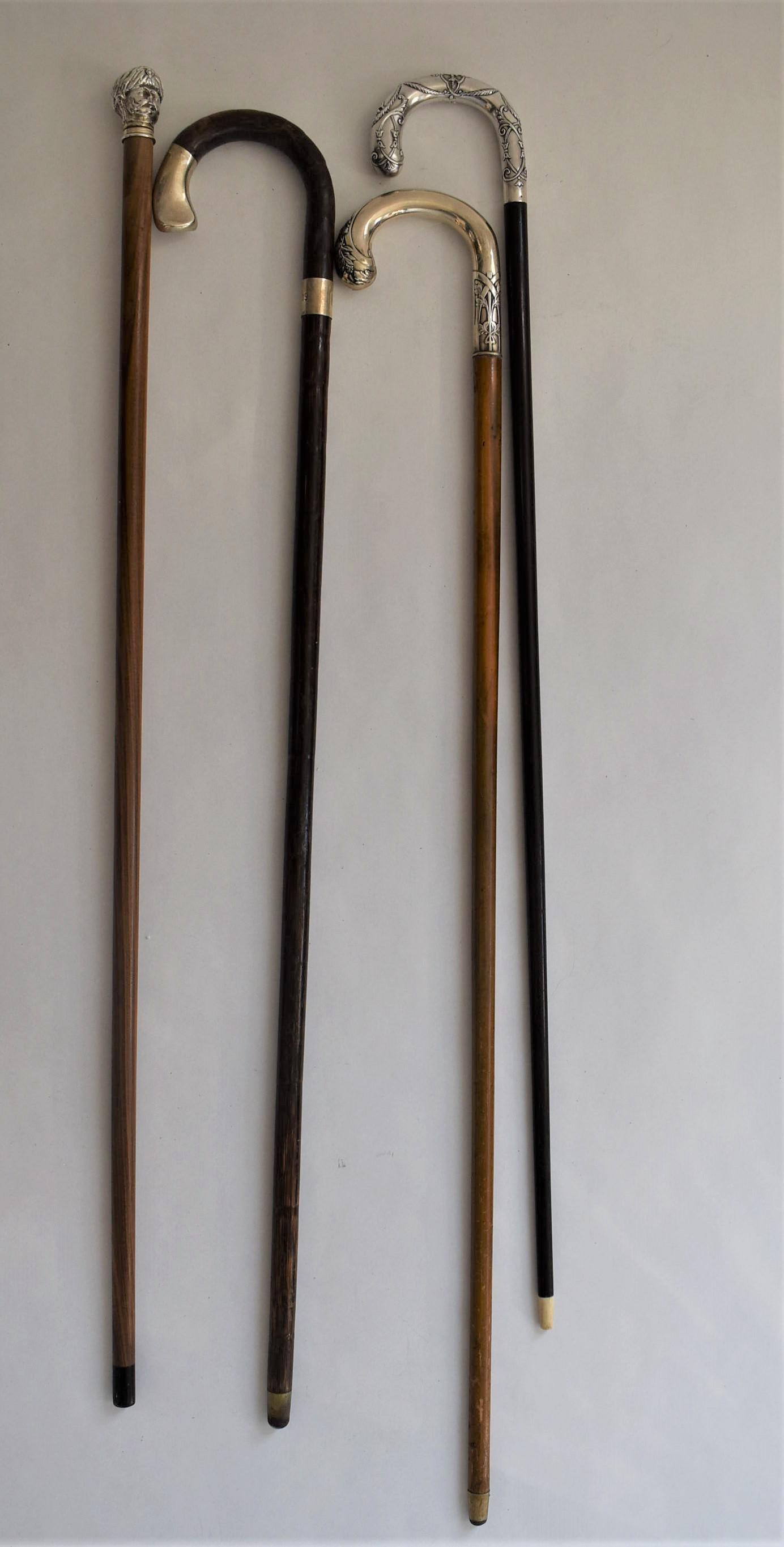 Antique continental canes /walking sticks, 3 silver mounted: A grouping of four antique continental canes, walking sticks including three with silver handles: one with a figural handle representing a turk? With turban ( 35.75"L, marks partly worn but tested and
