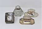 Grouping of English sterling silver inkwells and travel clock