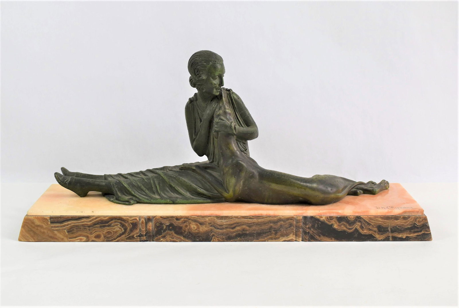 Art Deco patinated metal and onyx sculpture signed Chiparus: An Art deco period green patinated spelter sculpture of a seated female figure and a greyhound on a double onyx base. Onyx base signed " D.H. Chiparus" for Demetre Haralamb Chiparus (16 September 1886
