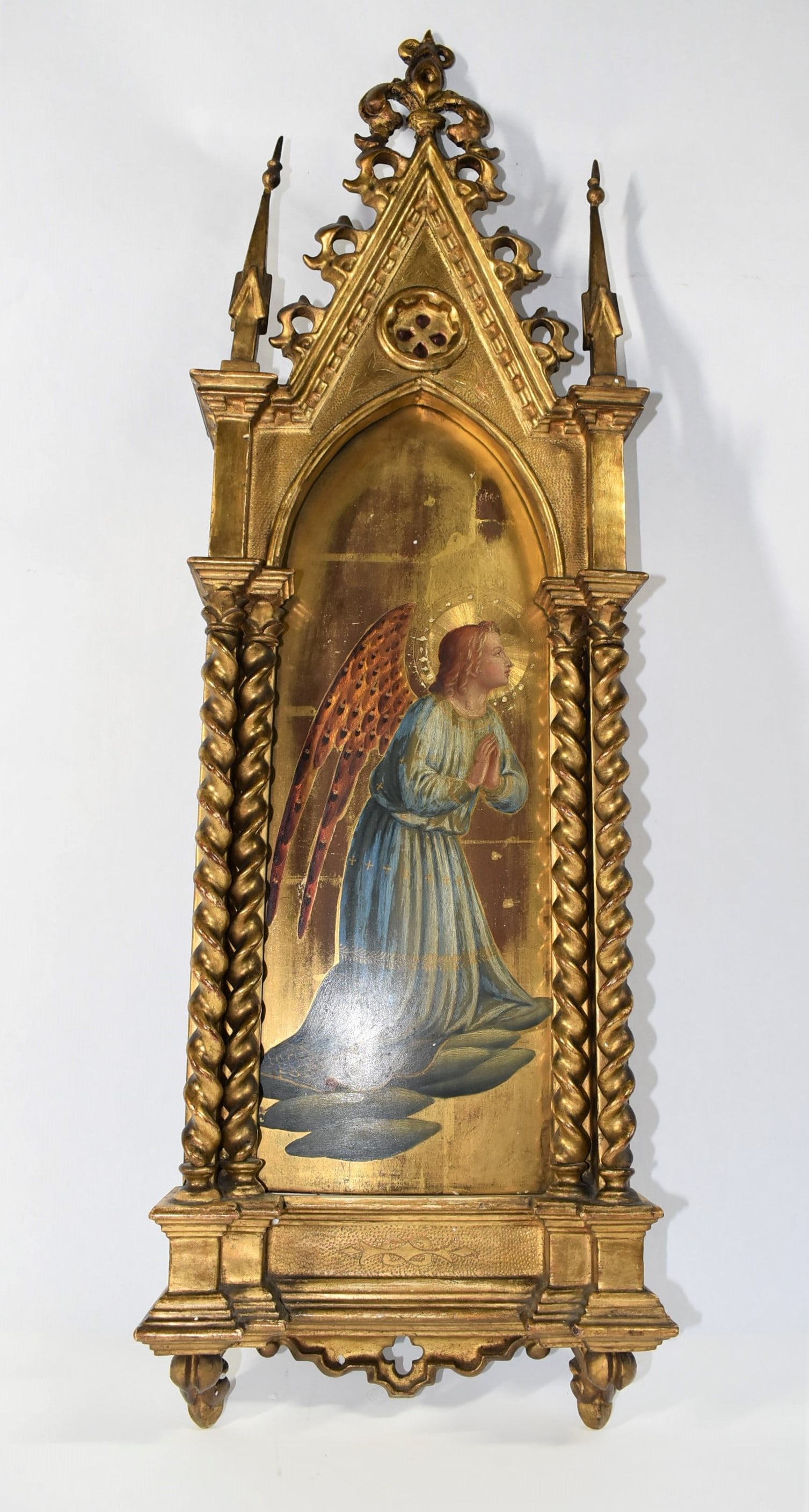 Antique 15th style carved and gilt wood altarpiece: An antique 14th/15th century Italian style carved and gilt wood altarpiece with central panel featuring an angel. Tempera on a gessoed and gilt wood background. Italy, 19th century. Approximate measur