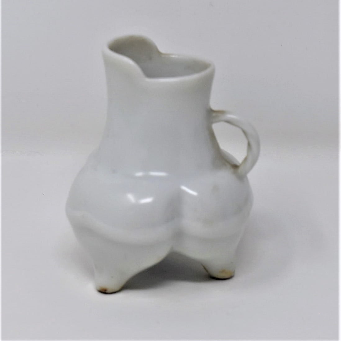 Miniature Chinese blanc de chine tripod pitcher: Miniature Chinese Blanc-de-chine or Dehua porcelain tripod pitcher with underglaze blue marks on the underside. From the Maria Anglesio estate, thence by descent to the present owner. Approximate meas