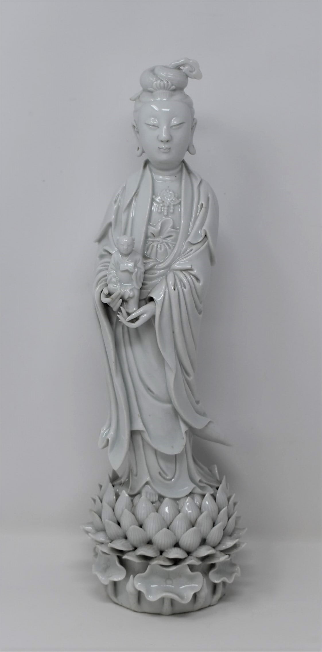 Chinese blanc de chine porcelain figure of Guanyin: An antique or vintage Chinese blanc de Chine, or Dehua porcelain figure og Guanyin standing on a lotus base. Apparently un-marked. From the Maria Anglesio collection, thence by descent to the present 