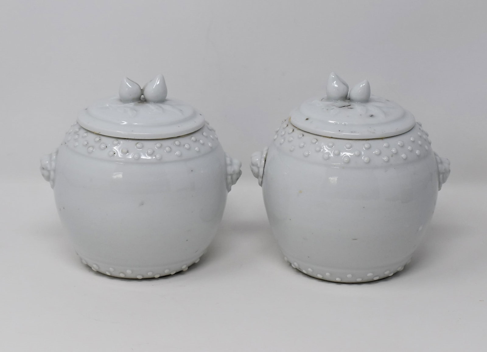 Pair of Chinese Blanc-de-Chine porcelain covered jars: A pair of antique or vintage Chinese blanc-de-Chine or Dehua porcelain jars and covers. Apparently un-marked. From the Maria Anglesio collection, thence by descent to the present owner. Approximate me
