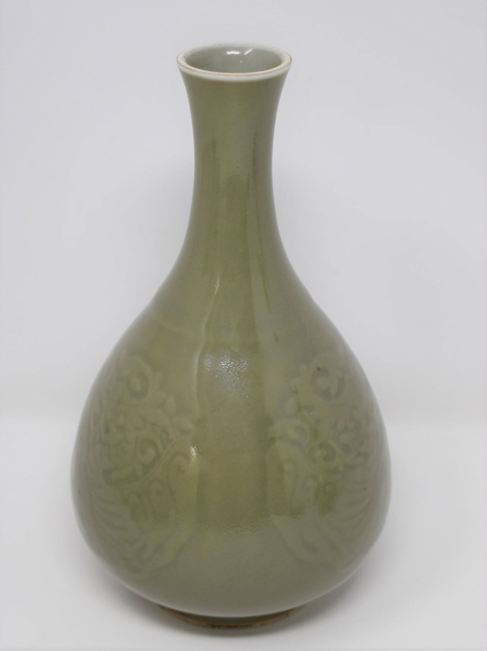 A Chinese celadon glazed Yuhuchunping-form vase: A vintage Chinese celadon glazed Yuhuchunping-form vase, carved with phoenix motif and with underglaze blue marks on the underside. From the Maria Anglesio collection, thence by descent to the present