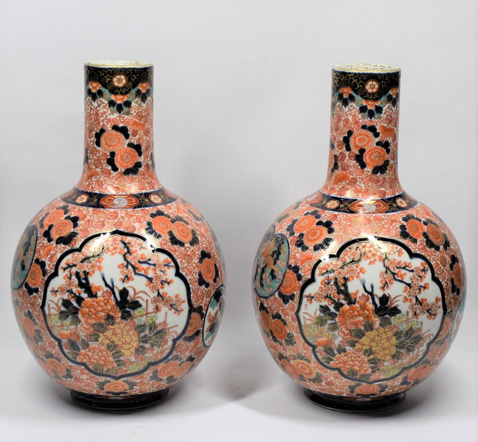 Pair of large Antique Fukuyama? Imari bottle vases: A pair of large antique Japanese Imari porcelain bottle vases. Possibly Fukuyama. Approximate measurements: 16"h x 10" in diameter Deker Auctions will not perform any shipping or packing services for 