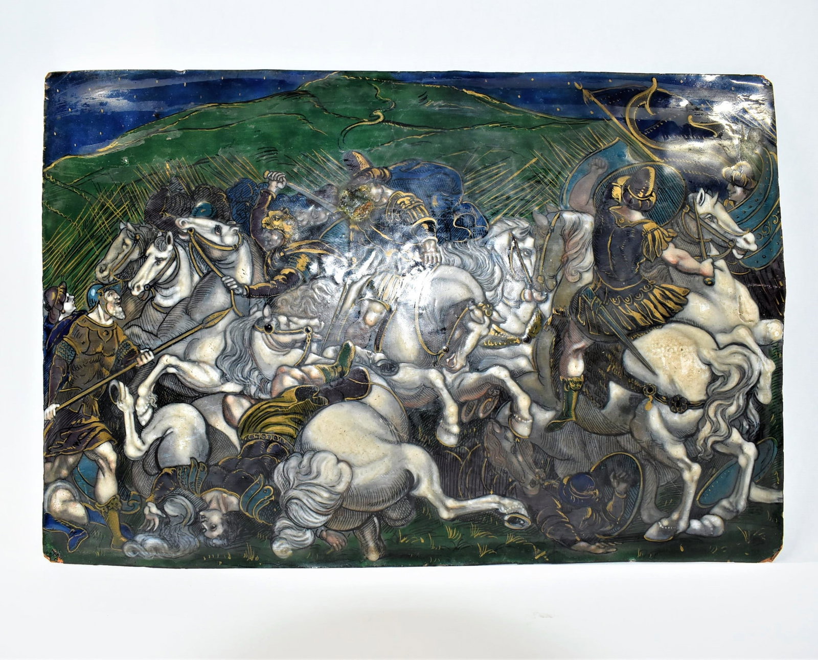 Antique Limoges enamel plaque of battle scene: An antique, 16th or 19th century Limoges enamel plaque on copper featuring a battle scene on horseback. Approximate measurements: 7.5"H x 11.25"L In-house domestic shipping is available for this lot. 