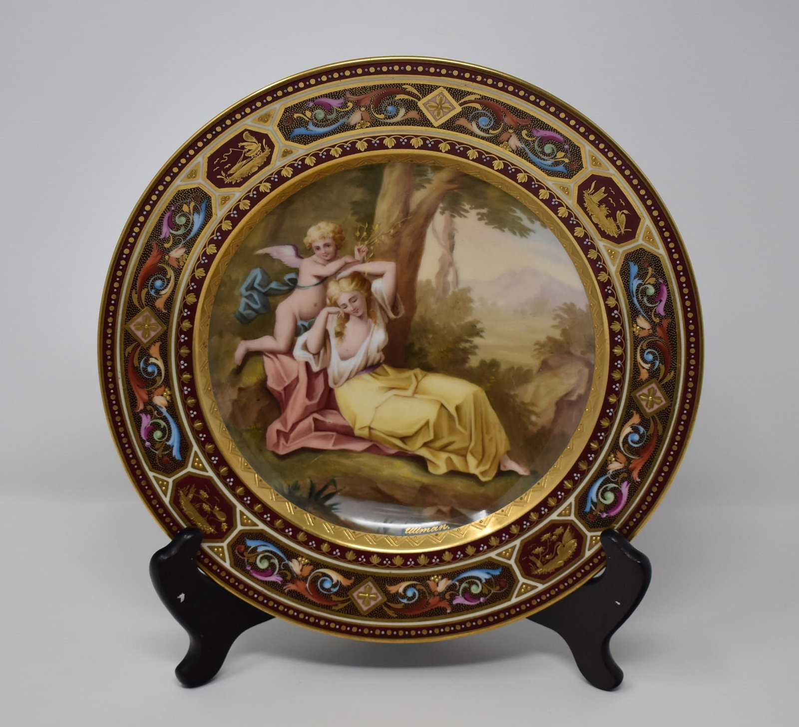 19th century Signed Royal Vienna porcelain plate: A signed "Ullman" Royal Vienna hand painted porcelain plate , " Venus and Amor", 19th century. From a Dix Hills NY estate. Approximate measurements: 9.5" in diameter In-house domestic shipping is avai