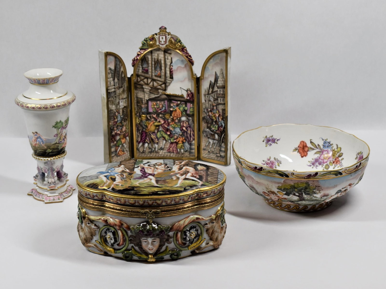 Grouping of four antique Capodimonte porcelain items: Grouping of four antique Capodimonte Italian porcelain items including a large hinged dresser box ( 4.25"H x 8.75"W x 6"D) a free standing renaissance style tryptich ( 10.25"H x 9.25"W) a large bowl (