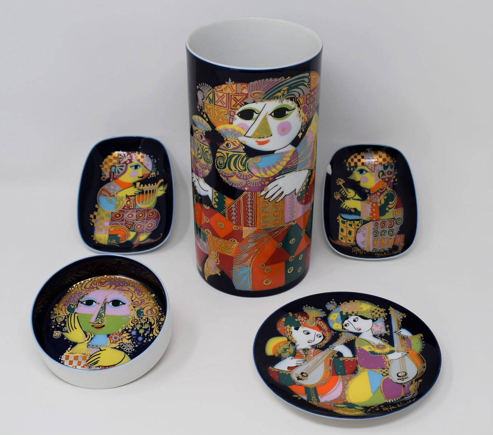 Grouping of five Bjorn Wiinblad for Rosenthal porcelain items: A grouping of five Bjorn Wiinblad for Rosenthal porcelain items including a tall cylindrical vase (8.75"h x 4.25" in diameter) and four small dishes of different shapes. From a Dix Hills, NY estate. D