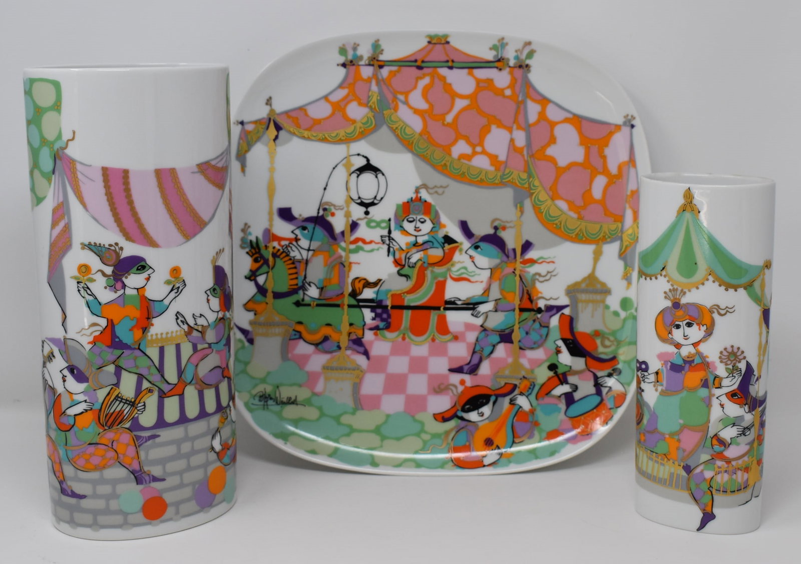 Three Bjorn Wiinblad for Rosenthal porcelain items, Commedia del'Arte pattern: Three Bjorn Wiinblad for Rosenthal porcelain items, Commedia del'Arte pattern including a large serving dish ( 12"W x 12"D), a tall vase (11"h x 4.75"W x 3.25"D) and a smaller vase (8.25"H x 3.25"W x 