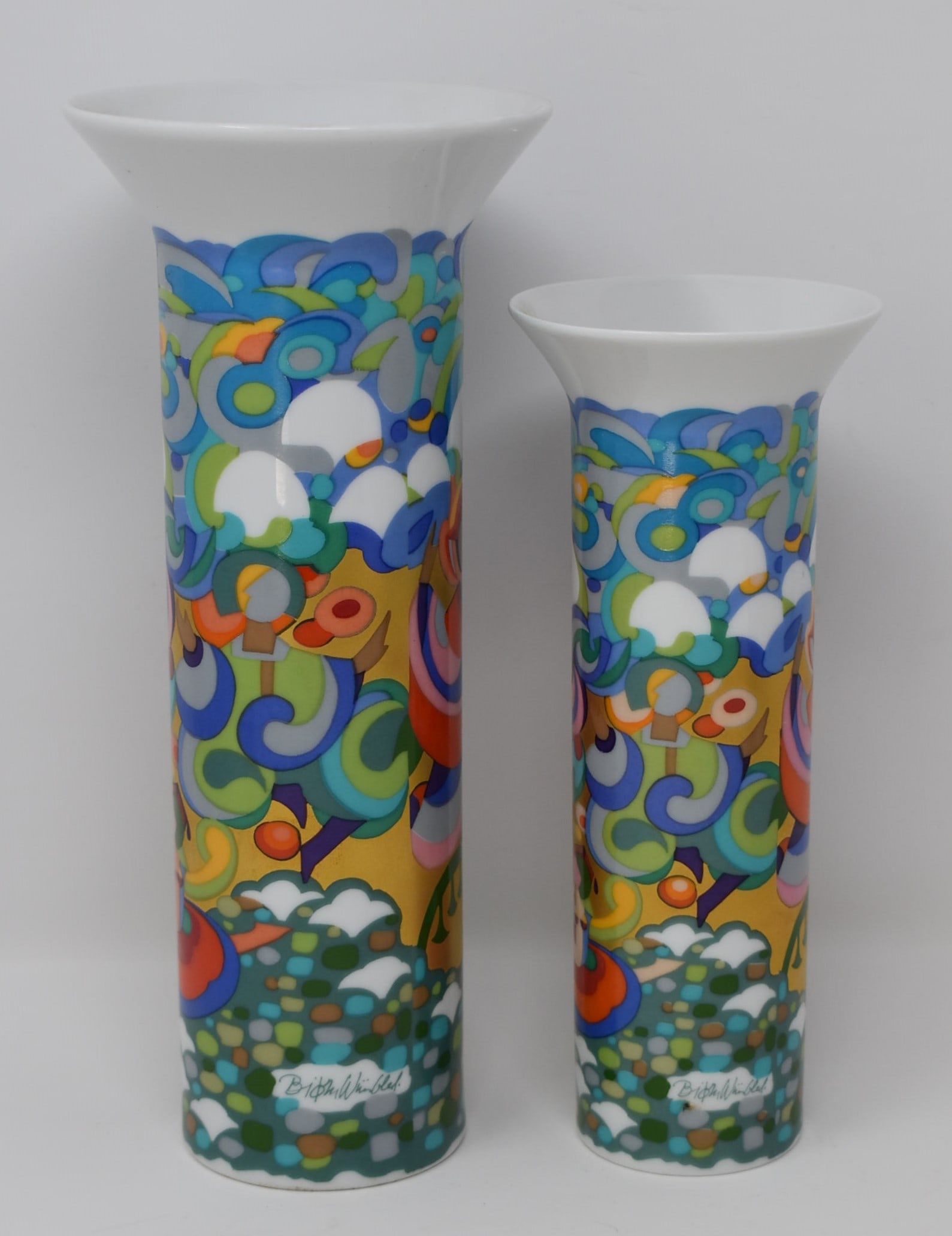 Two Bjorn Wiinblad for Rosenthal porcelain vases, Petruschka pattern: Two petruschka pattern Bjorn Wiinblad for Rosenthal porcelain vases. From a Dix Hills, NY estate. Measurements: 9.25"h x 4" in diameter and 7.5"h x 3" in diameter In-house domestic shipping is availab